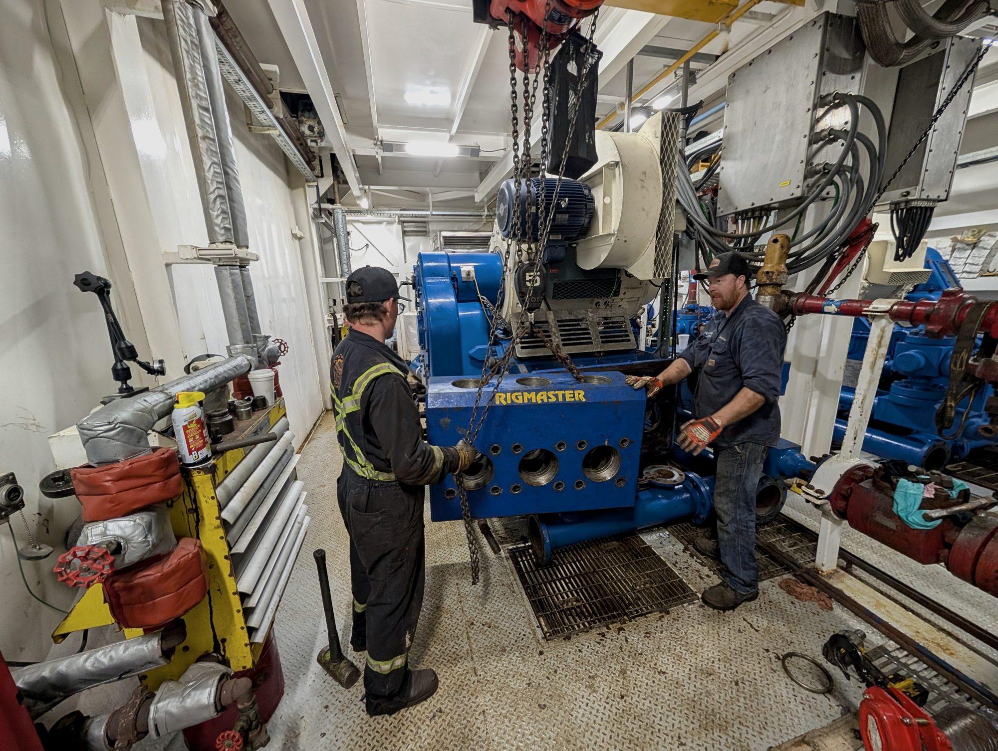 Crew lifting the fluid end